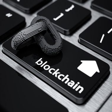 Image of a computer keyboard with a blockchain icon - representing how this emerging technology looks set to transform the property industry in the UK and across the globe.